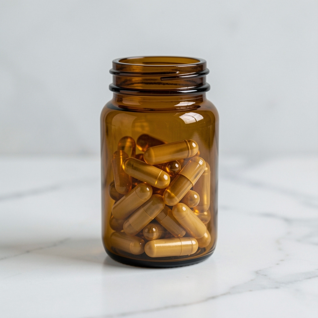 Omega-3 fish oil supplement capsules in an amber glass vessel on white marble surface, men's nutrition product photography with shallow depth of field